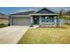 Charming one-story home with gray garage door and manicured lawn at 7018 162Nd E Pl, Parrish, FL 34219