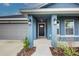 Inviting front entry with covered porch and stylish front door at 7018 162Nd E Pl, Parrish, FL 34219