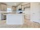 Modern kitchen with granite countertops, island, and stainless steel appliances at 7018 162Nd E Pl, Parrish, FL 34219