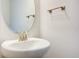 Small bathroom with pedestal sink, oval mirror, and brushed nickel fixtures at 16123 69Th E Ln, Parrish, FL 34219