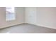 Bedroom with double doors and grey wall-to-wall carpet at 16123 69Th E Ln, Parrish, FL 34219