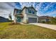 Two-story house with gray siding, teal accents, and a landscaped lawn at 16123 69Th E Ln, Parrish, FL 34219