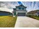 Two-story house with gray siding, teal front door, and attached garage at 16123 69Th E Ln, Parrish, FL 34219