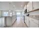 White kitchen with granite countertops and stainless steel appliances at 16123 69Th E Ln, Parrish, FL 34219