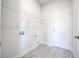 Bright laundry room featuring built-in shelving and vinyl flooring at 16123 69Th E Ln, Parrish, FL 34219