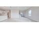 Open living space with grey tile floors, stairs, and lots of natural light at 16123 69Th E Ln, Parrish, FL 34219