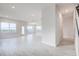 Open living room with gray tile floor and access to kitchen at 16123 69Th E Ln, Parrish, FL 34219