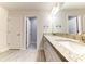 Double vanity bathroom with granite countertop and white cabinets at 6822 162Nd E Pl, Parrish, FL 34219