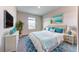 Bedroom with a king-size bed, blue bedding, and ocean art at 6822 162Nd E Pl, Parrish, FL 34219