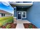 Exterior view of a charming blue house with a stone and wood accented front porch at 6822 162Nd E Pl, Parrish, FL 34219