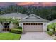 Two-story house with attached garage and landscaped yard at 604 Masterpiece Dr # 604, Sun City Center, FL 33573