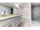Double vanity bathroom with granite countertop and shower at 6931 162Nd E Pl, Parrish, FL 34219