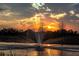Stunning sunset view over a pond with a water fountain at 6931 162Nd E Pl, Parrish, FL 34219
