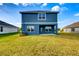 Two-story home with blue siding and grassy backyard at 6931 162Nd E Pl, Parrish, FL 34219