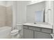 Clean bathroom with a gray vanity and tiled shower at 1279 Kazaz Ct, Zephyrhills, FL 33540