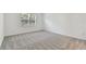 Simple bedroom with gray carpeting and a window with blinds at 1279 Kazaz Ct, Zephyrhills, FL 33540
