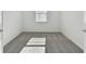 Spacious bedroom with gray carpeting and a window with blinds at 1279 Kazaz Ct, Zephyrhills, FL 33540