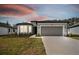 House exterior view with gray garage door at 1279 Kazaz Ct, Zephyrhills, FL 33540