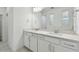 Bathroom with double vanity, quartz countertop, and subway tile at 1285 Kazaz Ct, Zephyrhills, FL 33540