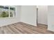 Bright bedroom with wood-look flooring and neutral walls at 1285 Kazaz Ct, Zephyrhills, FL 33540