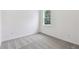 Simple bedroom with grey carpet and a window at 1285 Kazaz Ct, Zephyrhills, FL 33540