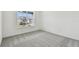 Bright bedroom with carpeted floor and large window at 1285 Kazaz Ct, Zephyrhills, FL 33540
