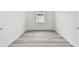 Simple bedroom with wood-look floors and neutral walls at 1285 Kazaz Ct, Zephyrhills, FL 33540