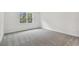 Bright bedroom with grey carpet and a window at 1285 Kazaz Ct, Zephyrhills, FL 33540