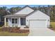 One-story house with gray siding, white trim, and a two-car garage at 1285 Kazaz Ct, Zephyrhills, FL 33540