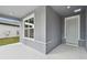Gray front porch with a light gray door and a window at 1285 Kazaz Ct, Zephyrhills, FL 33540