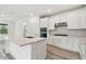 Modern kitchen with white cabinets, stainless steel appliances, and quartz countertops at 1285 Kazaz Ct, Zephyrhills, FL 33540
