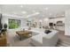 Open living room featuring a large sectional sofa and plenty of natural light at 1285 Kazaz Ct, Zephyrhills, FL 33540