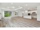 Spacious living room with wood-look floors and access to backyard at 1285 Kazaz Ct, Zephyrhills, FL 33540