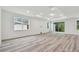 Open living area with wood-look flooring and lots of natural light at 1285 Kazaz Ct, Zephyrhills, FL 33540