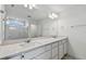 Modern bathroom with double vanity and large mirror at 1244 Kazaz Ct, Zephyrhills, FL 33540