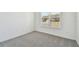 Simple bedroom with grey carpet and a window at 1244 Kazaz Ct, Zephyrhills, FL 33540
