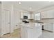 Modern kitchen featuring white cabinets and a large island at 1244 Kazaz Ct, Zephyrhills, FL 33540