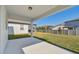 Covered patio overlooking a grassy backyard at 1244 Kazaz Ct, Zephyrhills, FL 33540