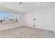 Spacious bedroom with large window and grey carpet at 1244 Kazaz Ct, Zephyrhills, FL 33540