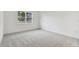 Simple bedroom with gray carpeting and a window at 37878 Clinch Cir, Zephyrhills, FL 33540