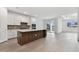 Modern kitchen with white cabinets, quartz countertops, and a large island at 37878 Clinch Cir, Zephyrhills, FL 33540