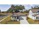 House with driveway and landscaping, viewed from above at 37886 Clinch Cir, Zephyrhills, FL 33540