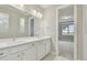 Double vanity bathroom with white cabinets and a view to another room at 37886 Clinch Cir, Zephyrhills, FL 33540