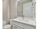 Bathroom with single vanity, white cabinets, and a view of the bathtub at 37886 Clinch Cir, Zephyrhills, FL 33540
