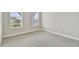 Bright bedroom with neutral carpeting and two windows at 37886 Clinch Cir, Zephyrhills, FL 33540