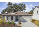 Single-story home with gray siding, stone accents and two-car garage at 37886 Clinch Cir, Zephyrhills, FL 33540