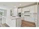 Modern kitchen with white cabinets and a large island at 37886 Clinch Cir, Zephyrhills, FL 33540