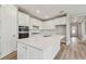 White kitchen with island and stainless steel appliances at 37886 Clinch Cir, Zephyrhills, FL 33540