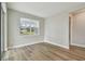 Bright and airy office space with wood-look flooring and large window at 37886 Clinch Cir, Zephyrhills, FL 33540
