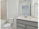 Clean bathroom with gray vanity and tile shower at 1209 Kistna Dr, Zephyrhills, FL 33540